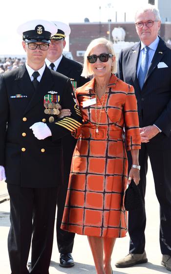 Dr. Susan DiMarco is escorted by Joseph Calhoun