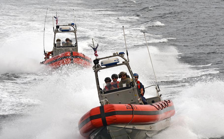 Two Coast Guard boats cruising.