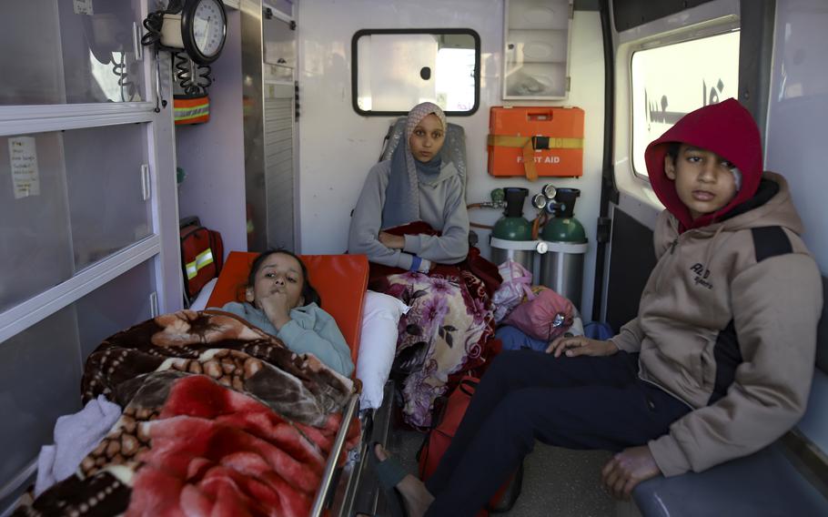 Palestinians wounded in the Israeli bombardment of the Gaza Strip wait inside an ambulance before crossing the Rafah border into Egypt.