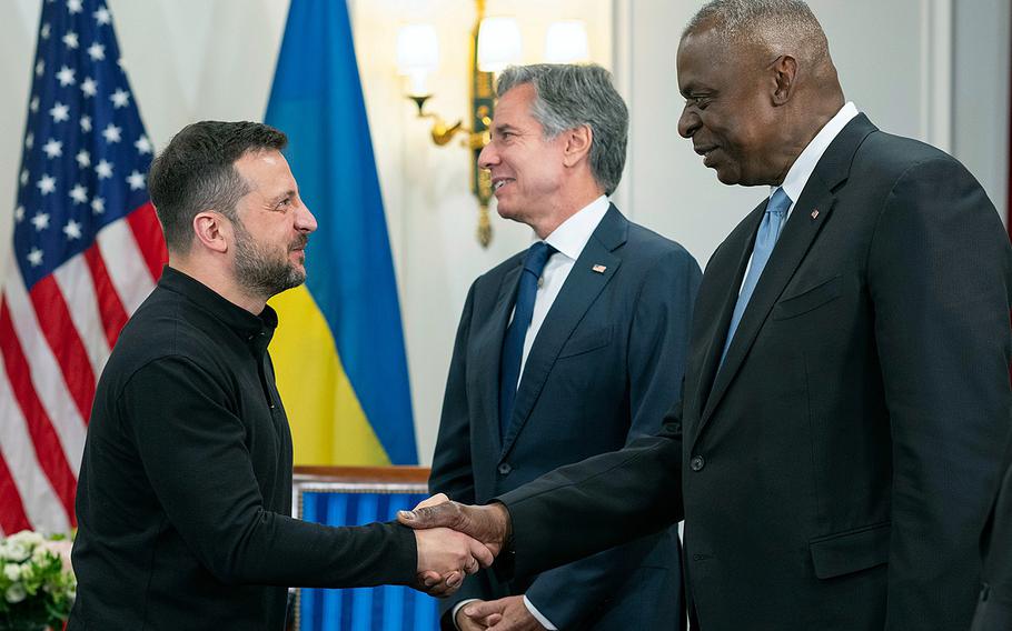 Defense Secretary Lloyd Austin shakes hands with Ukrainian President Volodymyr Zelenskyy in Paris.