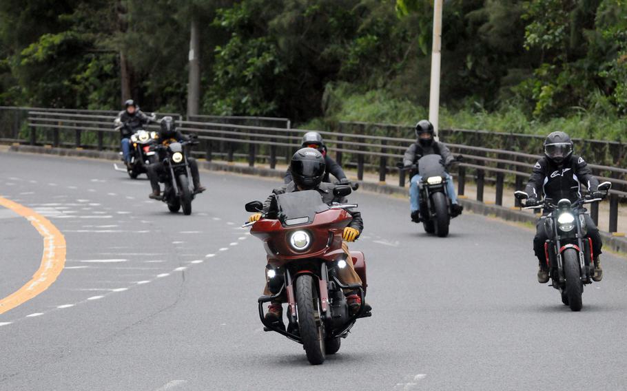 U.S. troops and members of the Okinawa American Legion cruise down Route 58 on their motorcycles.