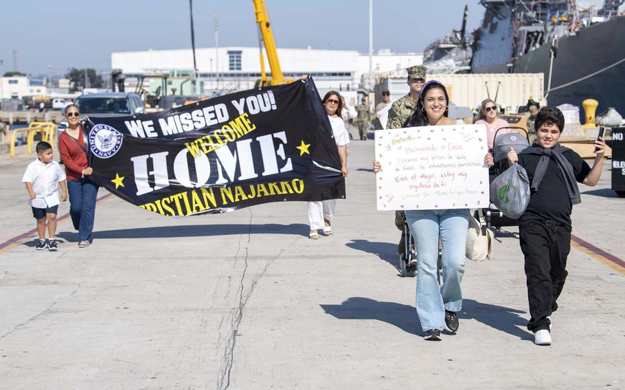 U.S. Navy Sailor Christian Najarro’s family welcomes him home with signs.