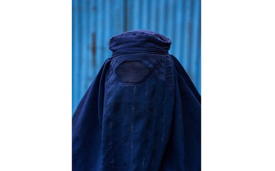 A woman in a burqa poses for a portrait in Ishkashim, Afghanistan, on Nov. 9, 2024. MUST CREDIT: Carolyn Van Houten/The Washington Post