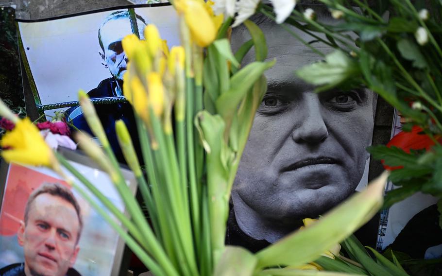 Flowers are seen placed around a portrait of late Russian opposition leader Alexei Navalny at a makeshift memorial in Frankfurt am Main, western Germany, on Feb, 29, 2024. 