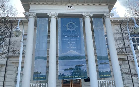 A white building with stone steps and columns that is now the Puget Sound Navy Museum.