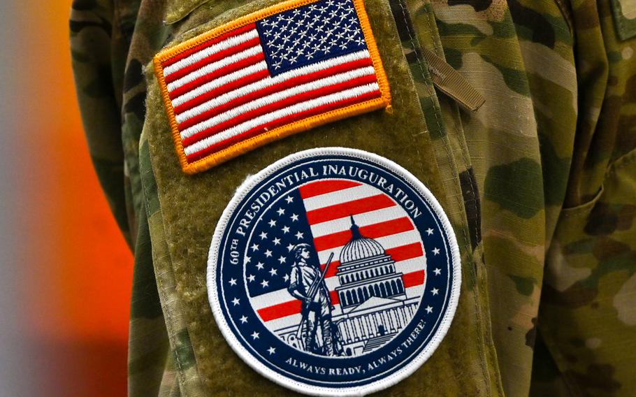 On the shoulder of an National Guard member are an American flag and a special patch for participation in the inauguration of Donald Trump. The patch says: 60th Presidential Inauguration; Always ready, always there over a picture of a service member holding a rile, and in the background the U.S. flag and the Capitol.