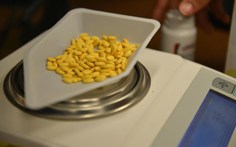 Pills lay on top of an automated scale at Shaw Air Force Base, S.C., March 29, 2017. 