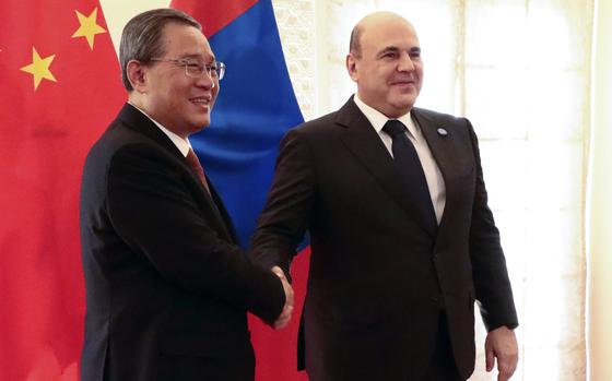 Chinese Premier Li Qiang, left, and Russian Prime Minister Mikhail Mishustin pose for a photo on the sidelines of the Shanghai Cooperation Organization (SCO) Council of Heads of Governments Summit in Islamabad, Pakistan, Wednesday, Oct. 16, 2024. (Alexander Miridonov, Sputnik, Government Pool Photo via AP)