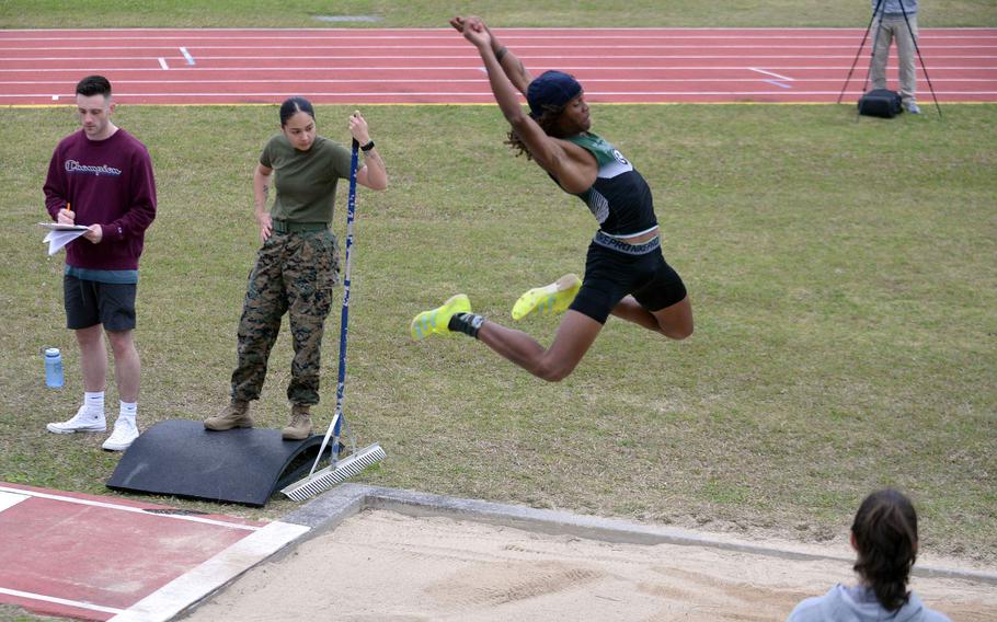 Kubasaki's Carlos Cadet goes airborne in the long jump during Friday's first day of a two-day Okinawa track and field meet. Cadet won the event in 5.96 meters.