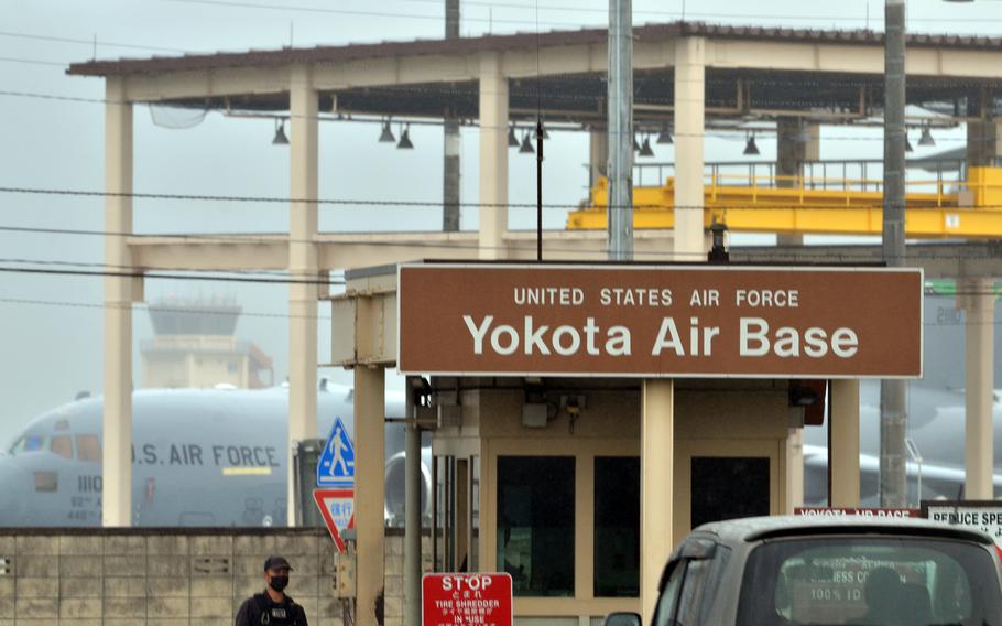 A sign with a brown background reads “United States Air Force Yokota Air Base.”