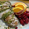 Sweet treats made with pistachio cream, including this croissant sprinkled with powdered sugar, are one of NEO Cafe Deli's specialties. Pistachio pancakes, with fruit and pistachio cream, are one of the most popular breakfast items on the menu, according to the owners.