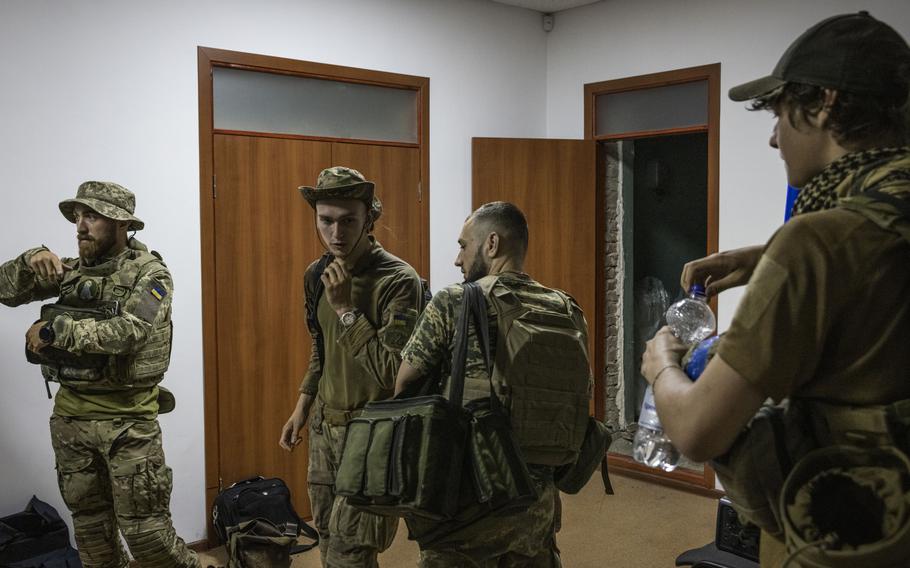 Soldiers with the call signs Labrador, left, Witcher, 19, center left, Chuck, center right, and Miami get ready on a base in Zaporizhzhia, Ukraine, to go to the front line before dawn in July. The Washington Post spent the night and morning with a unit from Ukraine’s 78th Assault Regiment using Kamikaze and surveillance drones on the Zaporizhzhia front line.