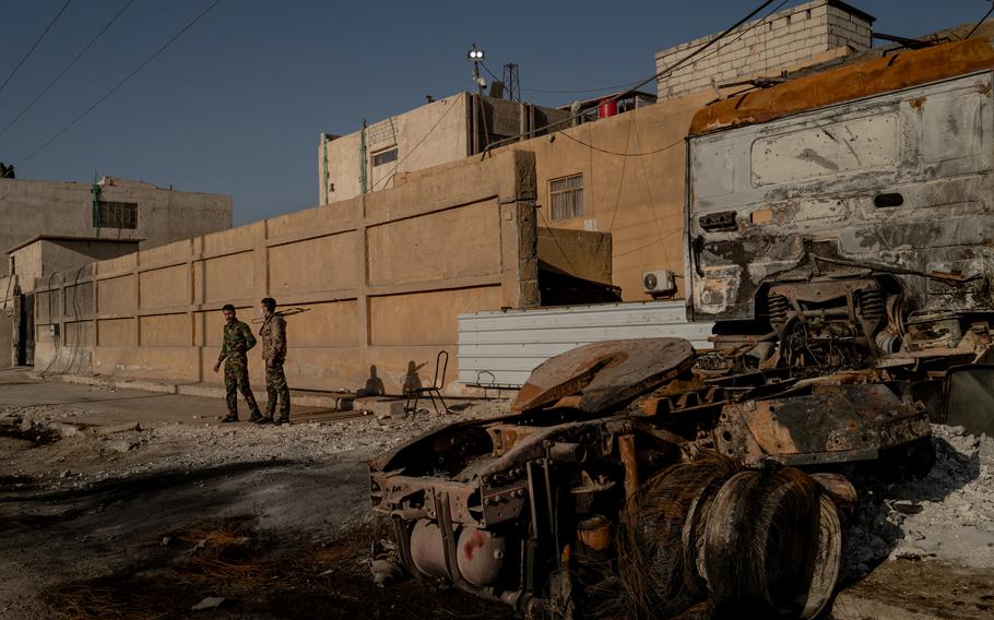 SDF members guard a prison complex in Hasakah in February 2022. 