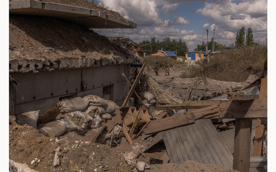 Ukrainian servicemen guard an area at a destroyed border crossing point with Russia, in the Sumy region, on Aug. 14, 2024, amid Russia’s invasion of Ukraine. 