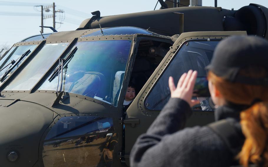 A child poses inside a UH-60L Black Hawk.