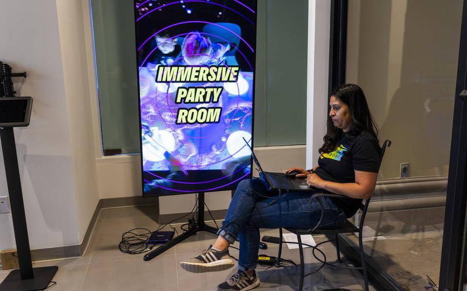 Financial Controller Patricia Garrett sets up an electronic reader board near the entrance at Electric Playhouse, a new high-tech social gaming place opening soon at The Forum Shops at Caesars on June 14, 2024, in Las Vegas. 