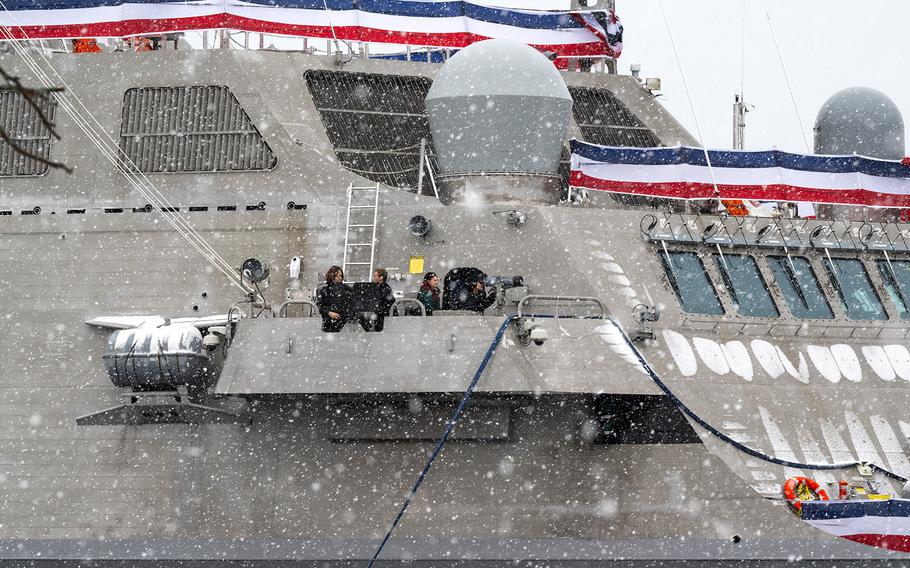 A group tours the docked USS Beloit on a snowy day, two days before its commissioning.