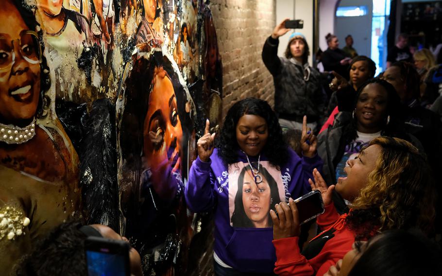 Tamika Palmer, right, Breonna Taylor’s mother, sings during an unveiling of a painting of Breonna Taylor on March 12, 2022, in Louisville.