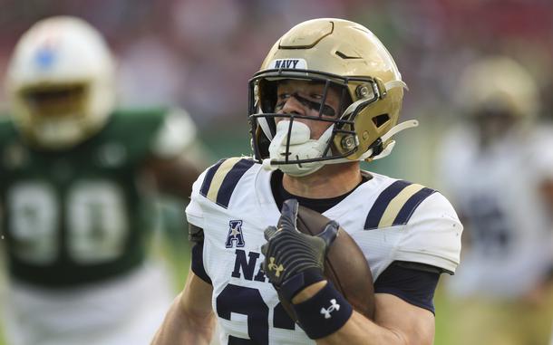 Navy running back Eli Heidenreich runs for a touchdown in the first quarter of an NCAA college football game against South Florida, Saturday, Nov. 9, 2024, in Tampa, Fla. (Luis Santana/Tampa Bay Times via AP)