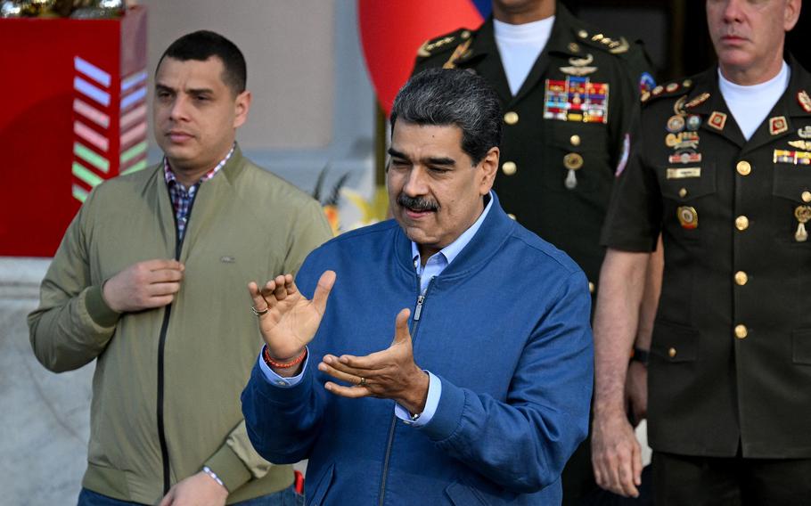 Venezuelan President Nicolas Maduro applauds during the arrival of Colombian businessman Alex Saab (out of frame) at the Miraflores Presidential Palace in Caracas on Dec. 20, 2023.