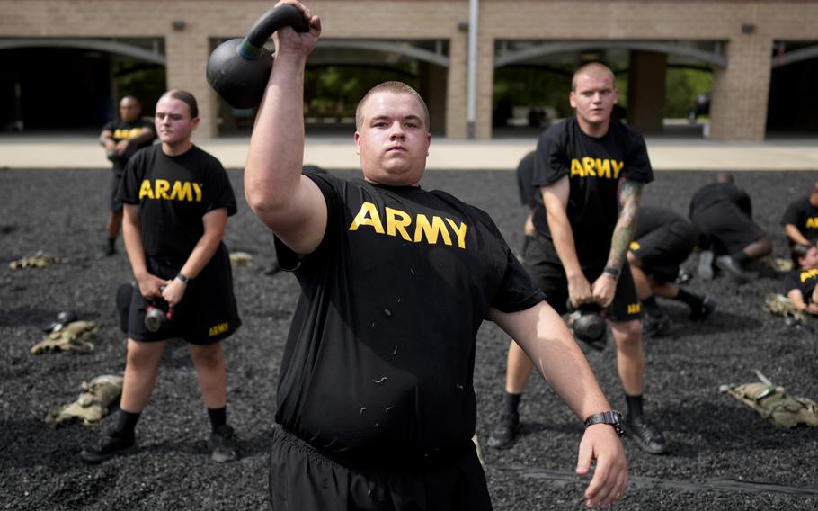 Army recruits lift weights during a soldier prep course.