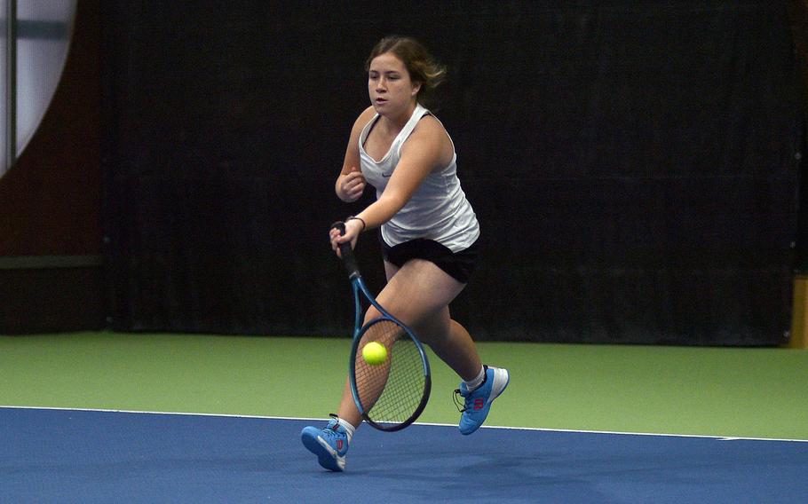 Liliana Stutzman runs to hit a ball.