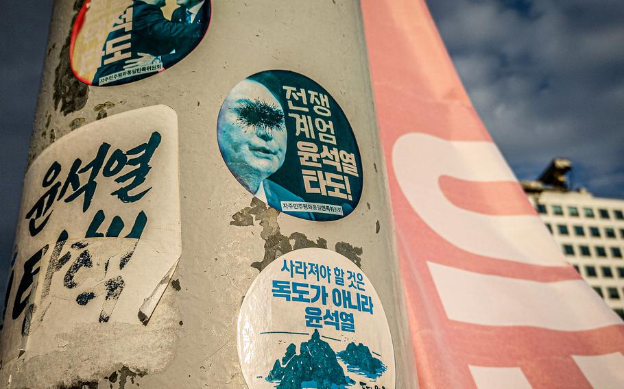 Images and stickers protesting South Korea’s president are displayed outside the National Assembly building in Seoul.