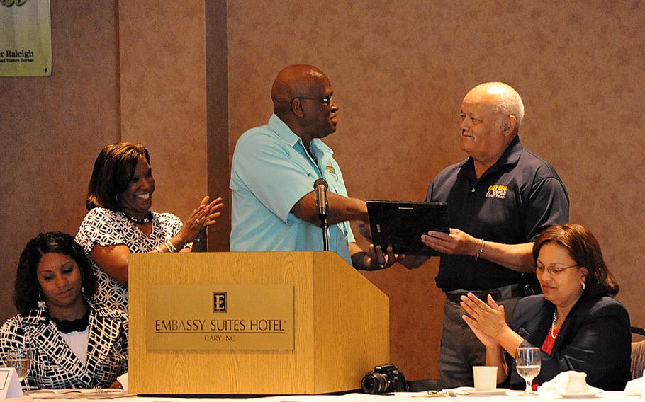 Retired U.S. Navy Master Chief Petty Officer William Goines, second from right, is recognized as a pioneer of swimming during the National Black Heritage Swim Meet Community Breakfast in Cary, N.C., May 28, 2010.