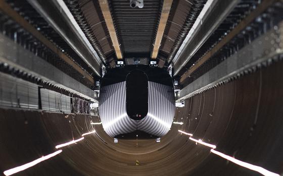 A test vehicle levitated by magnetic fields zips through a depressurized tube in a testing ground for a high-speed transit system during a press tour of a European test center for hyperloop transportation technology in Veendam, northern Netherlands, Friday, Sept. 6, 2024. (AP Photo/Peter Dejong)