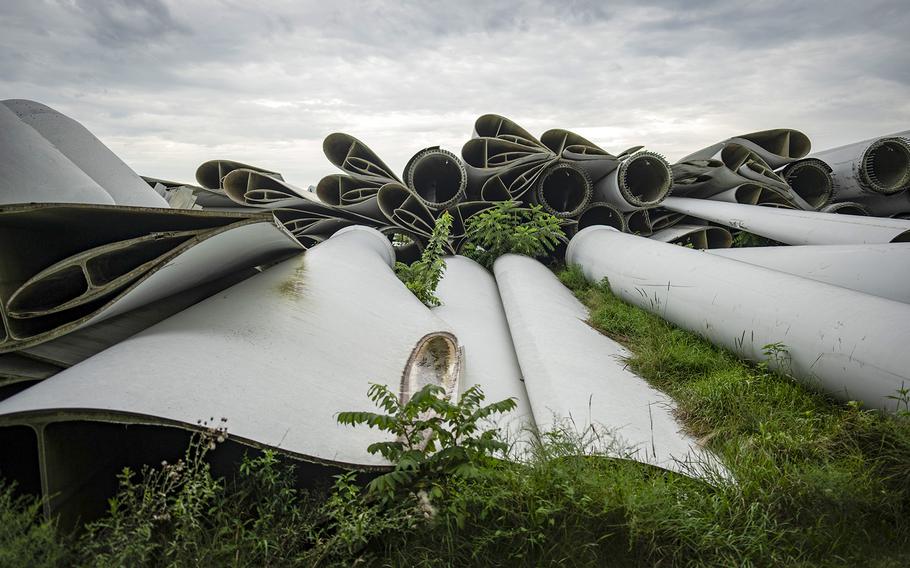 A pile of wind turbine parts is piled up along almost the entire west border of Darcy Richarson’s property in Grand Meadow, Minnesota on Aug. 7, 2024. Richardson worries about children getting hurt and rodents and animals nesting in the large empty cavities. 