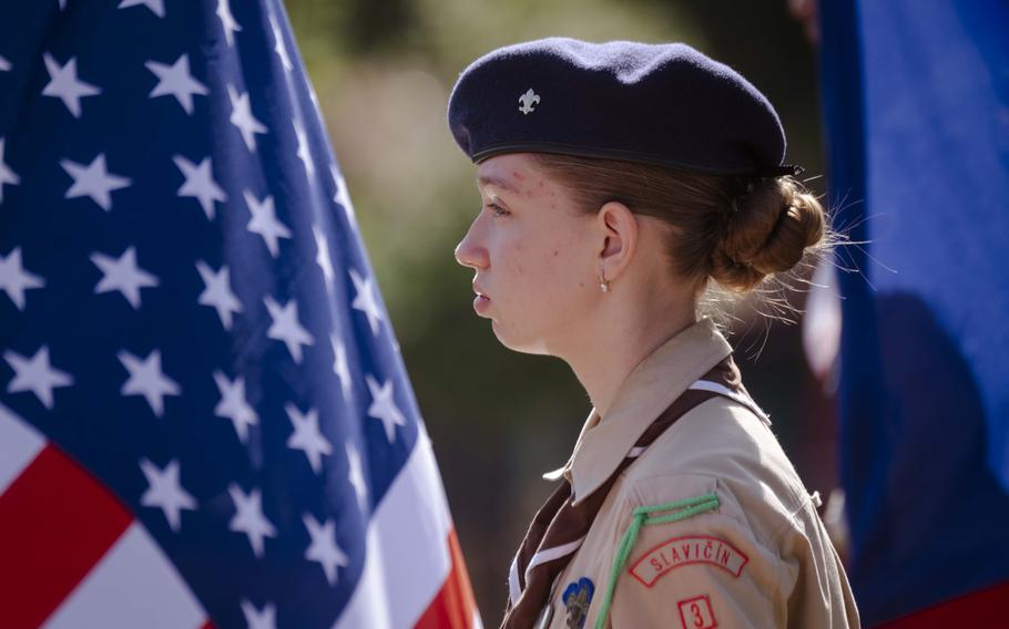 A Czech resident holds an American flag at the mass grave site of 28 fallen American airmen during the 80th commemoration of the Battle over the White Carpathians at Slavicin, Czech Republic, on Aug. 31, 2024.