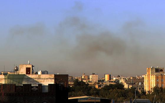 The skyline of Sanaa, Yemen is seen with a haze of smoke over it.