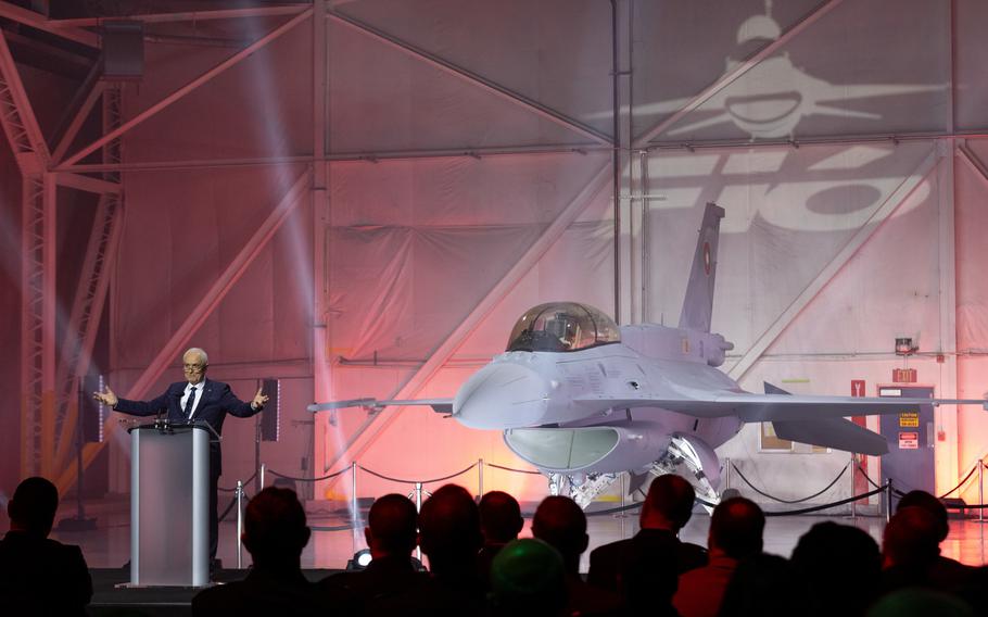 An F-16 is spotlighted during a news conference.