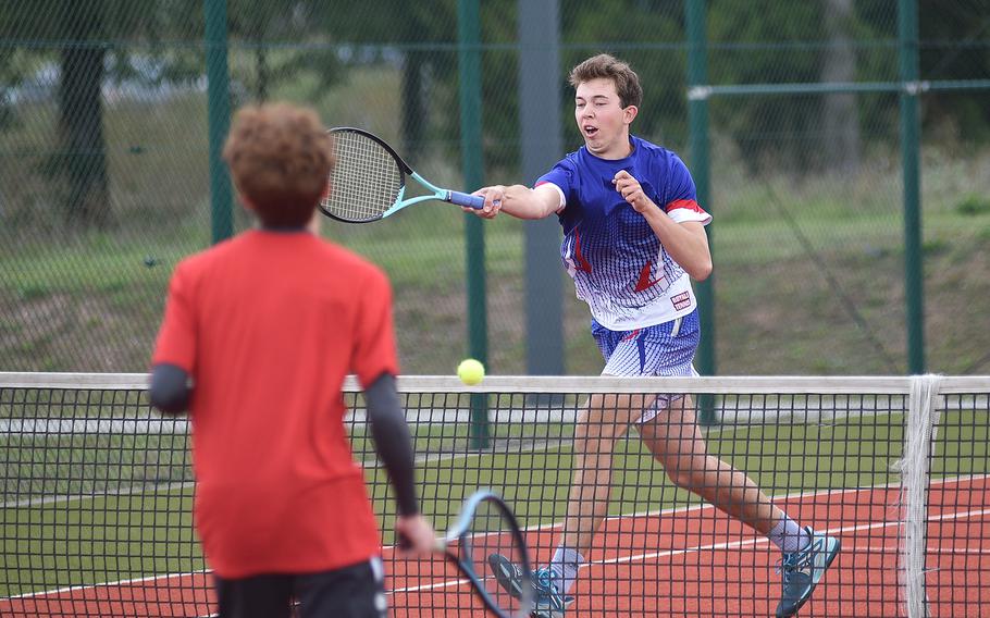 Ramstein's Elliot Radosevich hits the ball at the net in front of Kaiserslautern's Leo DiPaola during a boys doubles match on Sept. 14, 2024, at Ramstein High School on Ramstein Air Base, Germany.