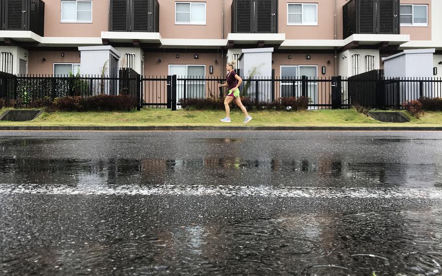 A runner takes advantage of slackening rain as Tropical Storm Shanshan churns near Marine Corps Station Iwakuni, Japan, Friday, Aug. 30, 2024.