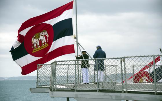 Thai sailors adjust their navy’s flag