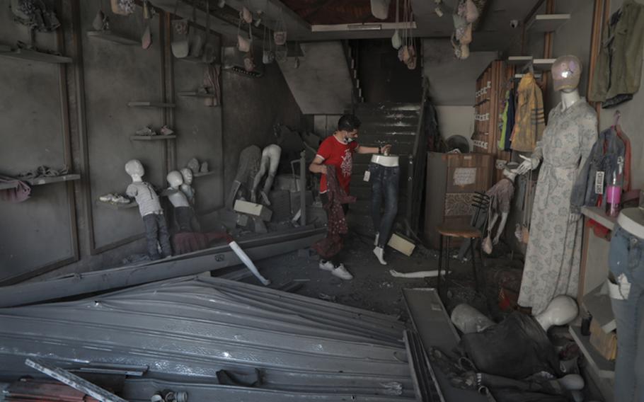 Bilal Mansour surveys his bombed-out Gaza City shop on Sunday, May 23, 2021.