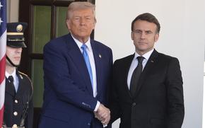 Donald Trump and Emmanuel Macron shake hands and pose outside a door to the White House.