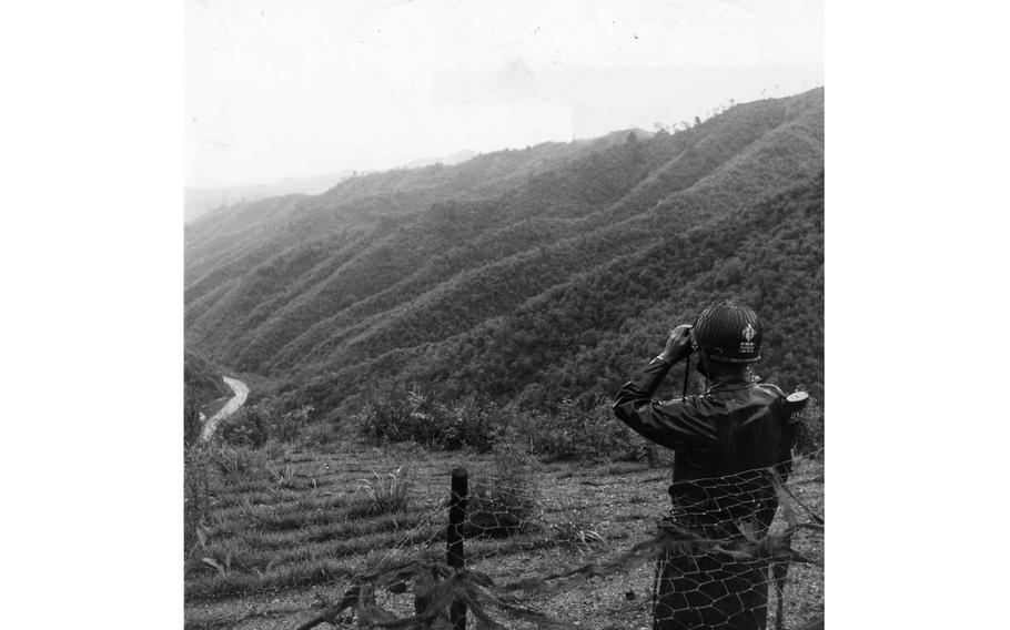 A platoon leader with the 1st Republic of Korea Division looks through a set of binoculars toward North Korea from his position in the Demilitarized Zone. 