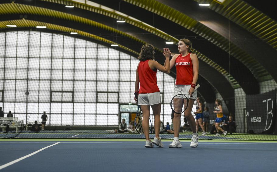 Kaiserslautern's Alisa Dietzel and Abby Hover share a celebratory high five during their victorious doubles match against Vicenza's Annika Svenson and Addie Wilson at the DODEA European tennis championships at T2 Sports Health Club in Wiesbaden, Germany, on Oct. 21, 2023.