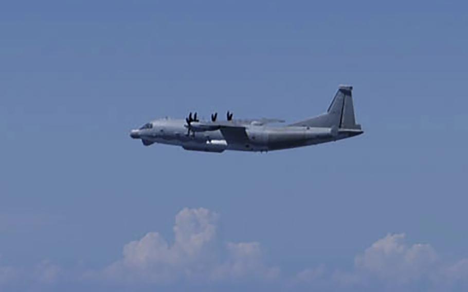  A Chinese Y-9 reconnaissance plane flies in a bright blue sky.