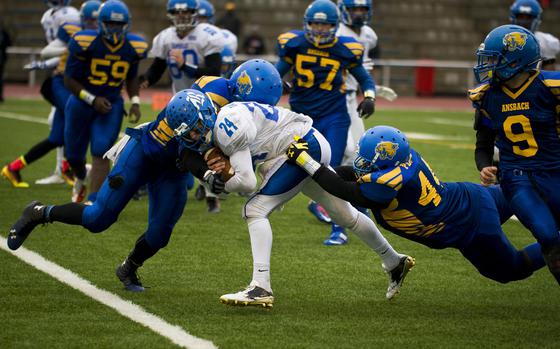 Vogelweh, Germany, Nov. 5, 2016: Ansbach's Joxua Baughman, left, and Ramon Peguero bring down Rota's Samuel Gallardo during the DODEA-Europe Division II championship.at Vogelweh, Germany, on Saturday, Nov. 5, 2016. Ansbach lost 28-7.

With DODEA football season in full swing, be sure to follow Stars and Stripes' DODEA sports coverage on our sports pages! 
https://www.stripes.com/sports/

META TAGS: DODEA; DODDS; sports; prep; football;