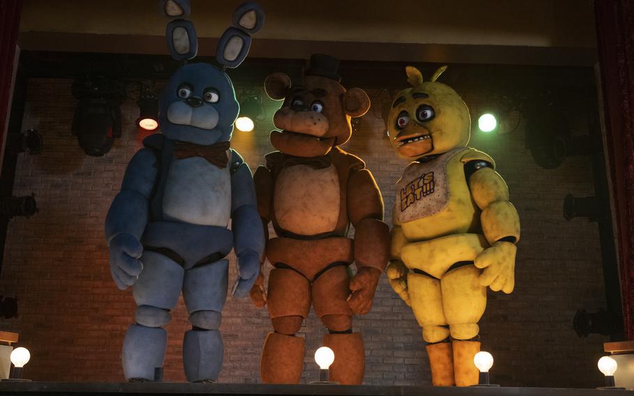 From left, Bonnie, Freddy Fazbear and Chica are three of the not-quite-terrifying-enough animatronic creatures that come to life in “Five Nights at Freddy’s.” 