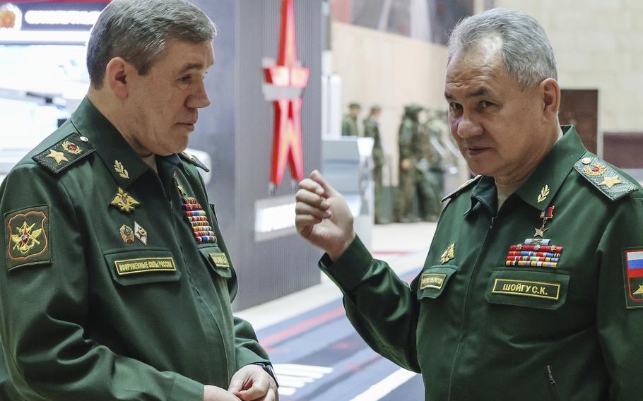 Russian Defense Minister Sergei Shoigu, right, gestures as he speaks to Russian Chief of General Staff Gen. Valery Gerasimov prior to a meeting Russian President Vladimir Putin with the top military brass in Moscow, Russia, Tuesday, Dec. 19, 2023. The International Criminal Court issued arrest warrants Tuesday for Russia’s former defense minister and its military chief of staff for attacking civilian targets in Ukraine.