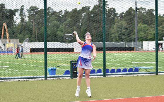 Ramstein's Gwyn Cedarholm serves during a girls doubles match against Kaiserslautern's Alisa Dietzel and Emma Bailey on Sept. 14, 2024, at Ramstein High School on Ramstein Air Base, Germany.