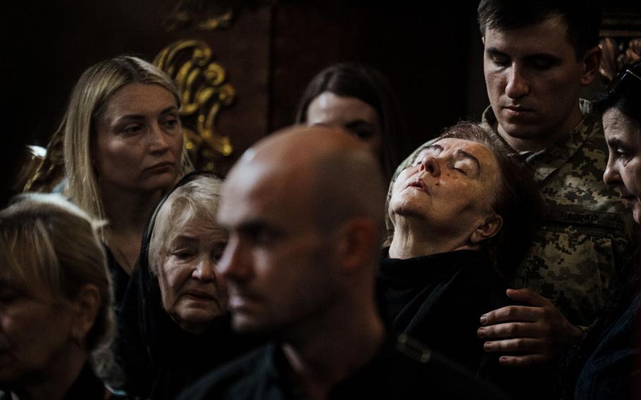 Uliana, 78, leans her head against a Ukrainian service member as she mourns for her son, Yuriy Sikyrynsky, during a military funeral for three soldiers killed in action at the Saints Peter and Paul Garrison Church in Lviv, Ukraine, Tuesday, June 20, 2023. Ukraine’s summer counteroffensive against invading Russian troops is exacting a heavy but undisclosed toll on the armies of both sides. In towns and cities across Ukraine, as bodies are returned home for burial, the burden of grief grows.