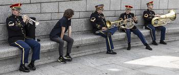 Members of the U.S. Army Brass Quintet are joined by a fan as they get ready for the 20th anniversary celebration of the National World War II Memorial in Washington, D.C., May 25, 2024.