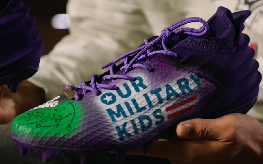 The custom designed “Our Military Kids” cleats are unveiled