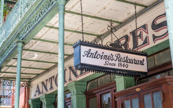 A hanging sign in front of Antoine’s in New Orleans reads “Antoine’s Restaurant Since 1840.”