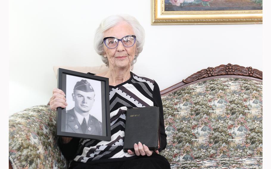 Lucille Hoback Boggess holds a photograph of her brother Raymond Hoback and his bible. Bedford and Raymond Hoback, two brothers from Bedford, Va., were killed on Omaha Beach in the first wave on D-Day.